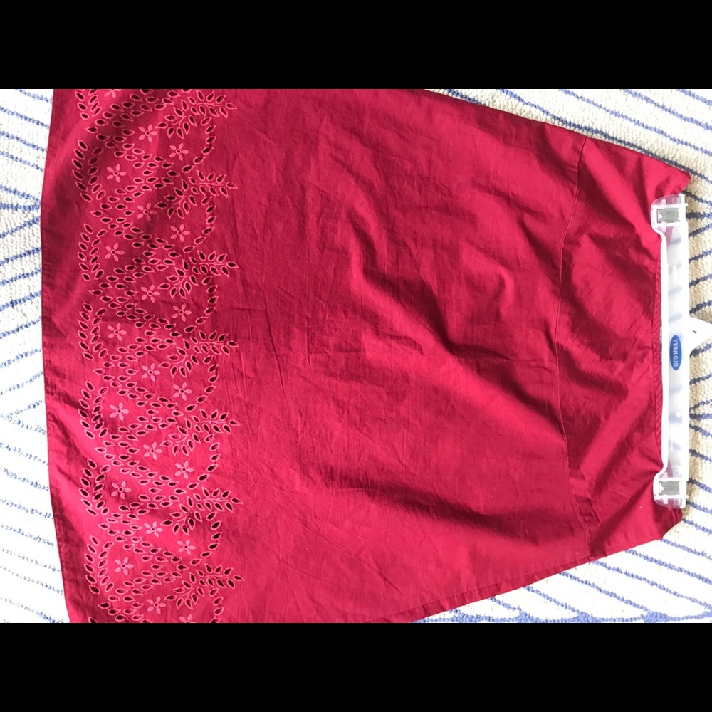 Red gap skirt with laser cut flower detail.